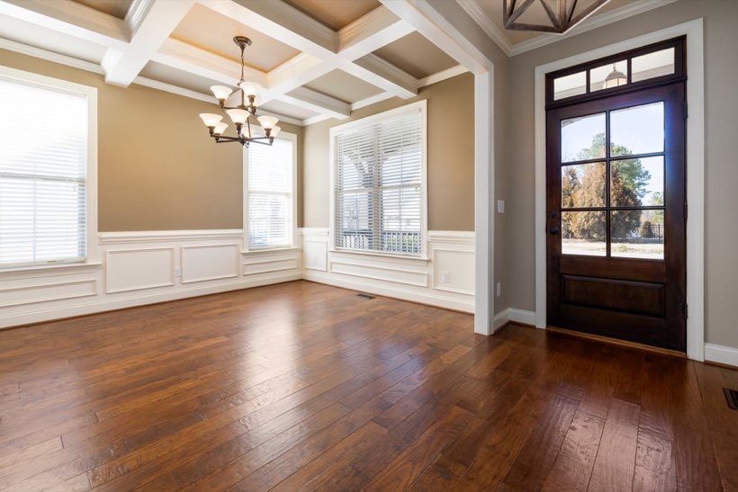 A formal dining room in an older Glenora home with dark stained oak flooring.