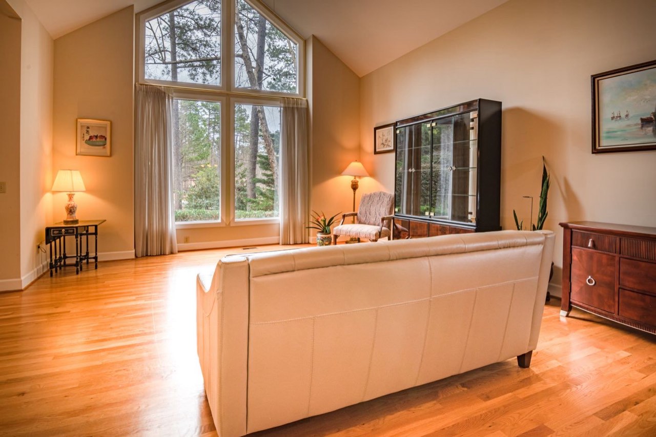 Warm oak flooring running through the living room of a Bonnie Doon house in Edmonton.